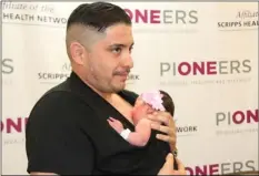  ?? WILLIAM ROLLER PHOTO ?? Kristian Herrera holds his 1-day-old daughter Camila on Friday at Pioneers Memorial Healthcare District perinatal department in Brawley.