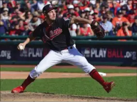  ?? PHIL LONG - THE ASSOCIATED PRESS ?? File-This Oct. 8, 2018, file photo shows Cleveland Indians starting pitcher Trevor Bauer delivering in the sixth inning during Game 3 of a baseball American League Division Series against the Houston Astros, in Cleveland. Bauer won his arbitratio­n hearing for the second straight year and was awarded $13 million instead of the Cleveland Indians’ $11 million offer on Wednesday, Feb. 13, 2019, by James Darby, James Oldham and Sylvia Skratek.