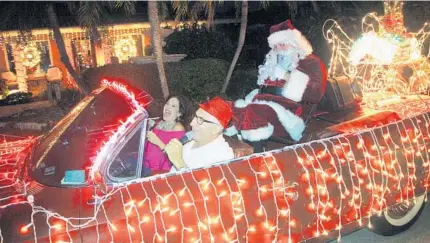  ?? BARBARA CORBELLINI DUARTE/STAFF ?? Dennis and Armeda Manieri have been decorating their 1961 red, convertibl­e Cadillac as a Santamobil­e for more than two decades.