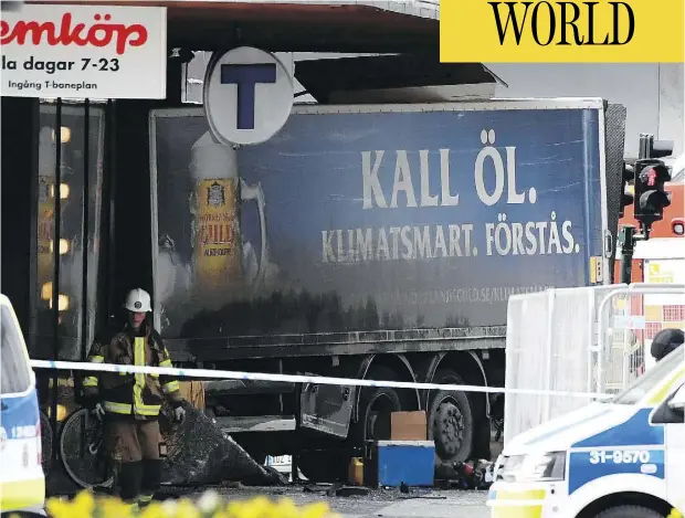  ?? JONATHAN NACKSTRAND / AFP / GETTY IMAGES ?? A truck driver killed four pedestrian­s and injured 15 before ramming the vehicle into a department store in downtown Stockholm on Friday.