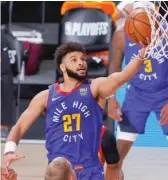  ?? KEVIN C. COX/GETTY IMAGES ?? The Nuggets’ Jamal Murray glides in for two of his 50 points Sunday against the Jazz in Game 6 of their firstround playoff series.