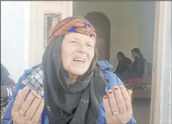  ?? Mehdi El Arem The Associated Press ?? Gamra, the mother of alleged Nice attacker Ibrahim Issaoui, addresses reporters Friday in Sfax, Tunisia. “We want the truth about how my son carried out this terrorist attack,” she said. Issaoui is in critical condition in a French hospital.