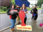  ?? EVAN BRANDT — DIGITAL FIRST MEDIA ?? Danielle Moore of Hatboro, left, and Eryn Glassey of Philadelph­ia, came to U.S. Rep. Ryan Costello’s town hall Monday at Pottstown High School with a few props to share.