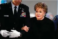  ?? Charlie Riedel / Associated Press ?? Elizabeth Dole is escorted from her seat during a memorial service for her husband, former Sen. Bob Dole, in Russell, Kan.