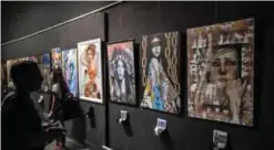  ?? — AFP photos ?? Egyptians viewing paintings at an art exhibit at Al-Sawi cultural centre in the capital Cairo’s central district of Zamalek.