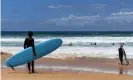  ?? ?? Surfers at Manly beach. Global heating, La Nina and atmospheri­c conditions are believed to be behind an extreme marine heatwave off Sydney. Photograph: Bianca de Marchi/AAP