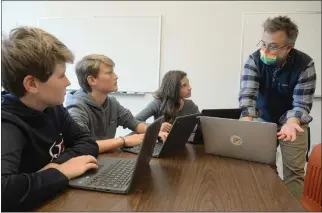  ?? ALAN DEP — MARIN INDEPENDEN­T JOURNAL ?? Ross School students Jack Hilleboe, left, Chip Sutro and Josephine Perlov confer with teacher Blake Schmidt this month about their land use proposal for a 1,640-acre site in Sonoma County.