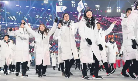  ?? Pictures: Getty. ?? The North Korea and South Korea Olympic teams enter together under the Korean Unificatio­n Flag during the Parade of Athletes.