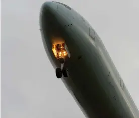  ??  ?? A plane lowers its undercarri­age as it descends for landing at London Heathrow airport. Photograph: Avpics/Alamy