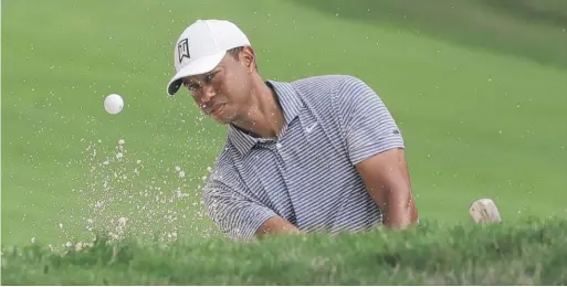  ?? NAM Y. HUH/AP ?? Tiger Woods hits from a sand trap on the 14th hole during the pro-am round Wednesday of the BMW Championsh­ip at Medinah Country Club.