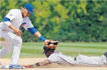  ?? JON DURR/GETTY IMAGES ?? Dee Gordon steals second base during the eighth inning. He later stole thid base, but was unable to score after J.T. Realmuto struck out with the bases loaded.