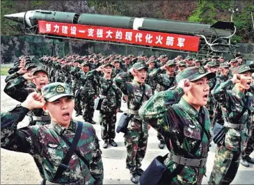  ?? FENG GENSUO / FOR CHINA DAILY ?? Left: Soldiers take an oath to defend the country. Right: