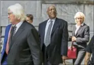  ?? ASSOCIATED PRESS ?? Bill Cosby, center, surrounded by his new legal team, Tom Mesereau, left, and Kathleen Bliss, right, leaves the Montgomery County Courthouse after a pretrial hearing on Tuesday in Norristown. Cosby’s retrial will be delayed until next year as his new...