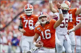  ?? RICHARD SHIRO — THE ASSOCIATED PRESS ?? Clemson quarterbac­k Trevor Lawrence (16) reacts after scoring a touchdown against Florida State on Saturday in Clemson, S.C.