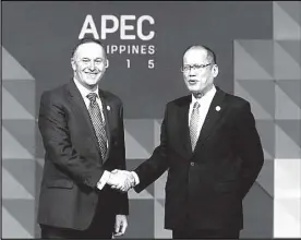  ?? EPA ?? New Zealand’s Prime Minister John Key (left) is greeted by President Aquino as he arrives for the Asia-Pacific Economic Cooperatio­n (APEC) leaders meeting in Manila.