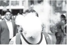  ??  ?? File photo shows a man uses a vape as he walks on Broadway in New York City, US.