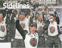  ?? JOHN BAZEMORE/THE ASSOCIATED PRESS ?? Kevin Harvick, center, celebrates after winning the NASCAR Cup Series race Sunday at Atlanta Motor Speedway in Hampton, Ga.