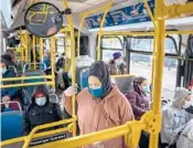  ?? JONAH MARKOWITZ/THE NEW YORK TIMES ?? Passengers wear masks on a bus in January in New York.