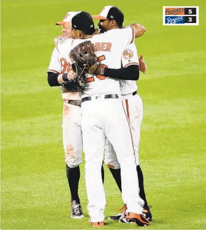  ?? ROB CARR/GETTY IMAGES ?? Outfielder­s, from left, Craig Gentry, Anthony Santander and Adam Jones celebrate after the Orioles ended a seven-game slide with a 5-3 victory over the Kansas City Royals on Wednesday night. The Orioles broke up a tie game with two runs in the eighth...