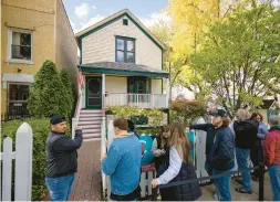  ?? ?? Visitors line up to enter the birthplace home of Walt Disney at the corner of North Tripp Avenue and West Palmer Street in Hermosa on Sunday during Open House Chicago. Disney was born on the second floor in 1901 and grew up there until his family moved to Missouri in 1906.