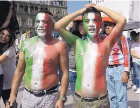  ?? MOISES CASTILLO/ASSOCIATED PRESS ?? Soccer fans in Mexico City watch a live telecast of Mexico’s Group F match Wednesday against Sweden. Although Mexico was defeated, it advanced to the knockout round.