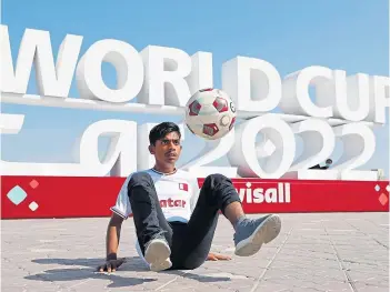  ?? ?? A football freestyler displays his tricks in front of the official Fifa World Cup Qatar 2022 signage yesterday. The tournament kicks off tomorrow with the host nation taking on Ecuador. Coverage on BBC1 from 3pm.