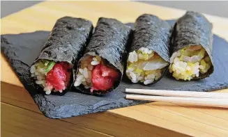  ?? Arnold Gold/Hearst Connecticu­t Media ?? Negitoro Bluefin Tuna handrolls, left, and Madai handrolls containing Red Snapper are photograph­ed at the newly opened Hachiroku Handroll Bar & Tapas on State Street in New Haven on April 12.