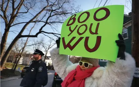  ?? NANCY LANE / HERALD STAFF ?? EARLY BIRD GETS THE BOOS : Protestors hold signs outside Mayor Michelle Wu’s house on Wednesday in Roslindale. On Friday, for the first time since the new law went into effect, five were cited for protesting too early in the morning outside the Mayor’s home.