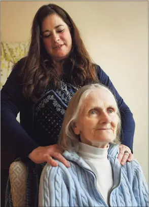  ?? Brian A. Pounds / Hearst Connecticu­t Media ?? Holly Batti, of Ridgefield, spends time with her mother, Gwenn Fiorito, who enjoys a good shoulder rub, in memory care at Greens at Cannondale in Wilton on Wednesday.