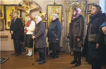  ?? FELIPE DANA AP ?? Ukrainians attend a Christmas Mass at an Orthodox Church in Bobrytsia, on the outskirts of Kyiv, Ukraine, Sunday. Orthodox Ukrainians celebrated Christmas in December instead of January for the first time.