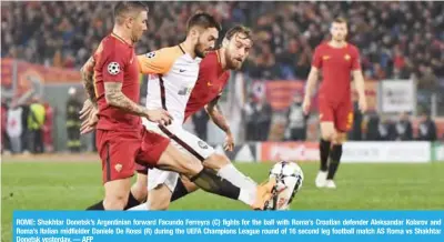  ??  ?? ROME: Shakhtar Donetsk’s Argentinia­n forward Facundo Ferreyra (C) fights for the ball with Roma’s Croatian defender Aleksandar Kolarov and Roma’s Italian midfielder Daniele De Rossi (R) during the UEFA Champions League round of 16 second leg football...