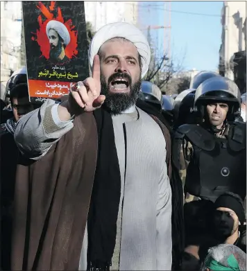  ??  ?? A Muslim cleric addresses a crowd in front of the Saudi embassy in Tehran Sunday, protesting the execution of Shiite Sheikh Nimr al-Nimr.