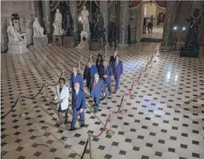  ?? JIM WATSON/AFP VIA GETTY IMAGES ?? House managers walk to the Senate to deliver the articles of impeachmen­t against President Donald Trump on Wednesday.