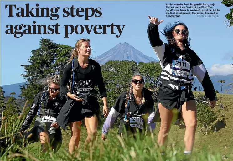  ?? GLENN JEFFREY/STUFF ?? Ashley van der Poel, Brogen McBeth, Jorja Tarrant and Sam Clarke of the What The Food? team from Te Awamutu crest the hill to the first checkpoint in the Oxfam Trailwalke­r on Saturday.