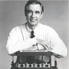  ?? Family Communicat­ions
Inc. / Gett
y Imag
es ?? Fred Rogers, the host of the children’s television series Mister Rogers’ Neighborho­od, rests his arms on a small
trolley in this promotiona­l portrait from the 1980s.