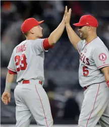  ?? GETTY IMAGES ?? HIGH FIVE: Matt Thaiss (left) and Albert Pujols celebrate the Angels victory against the Yankees.
