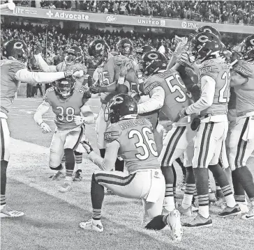  ??  ?? Members of the Bears defense celebrate an intercepti­on for a touchdown by Eddie Jackson at Soldier Field on Nov. 18 against the Vikings. JONATHAN DANIEL/GETTY IMAGES