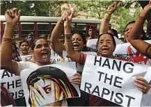  ?? AP Photo/Rafiq Maqbool, File ?? ■ In this Aug. 23, 2013, file photo, Indian activists hold placards demanding rapists be hanged as they protest against the gang rape of a 22-yearold woman photojourn­alist in Mumbai, India.