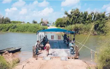  ?? CHRISTOPHE­R LEE/THE NEW YORK TIMES ?? A ferry transports people and sometimes vehicles across the Rio Grande River between the U.S. and Mexico, in Los Ebanos, Texas. The tiny community is a location for proposed expansions of the border wall.