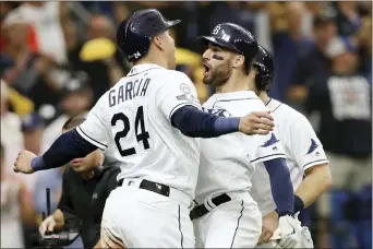  ?? CHRIS O’MEARA — THE ASSOCIATED PRESS ?? Tampa Bay Rays’ Kevin Kiermaier, right, celebrates his 3-run home run in the second inning against the Houston Astros with Avisail Garcia (24) during Game 3.