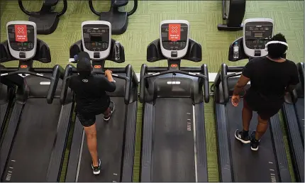  ??  ?? Gym members exercise between ‘do not use’ machines at Puregym in Leamington Spa