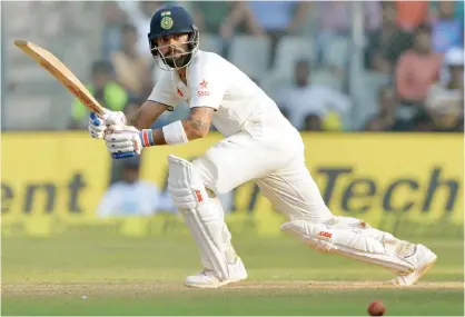  ??  ?? MUMBAI: India’s captain Virat Kohli plays a shot on the third day of the fourth Test cricket match between India and England at the Wankhede stadium in Mumbai yesterday. — AFP
