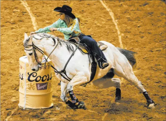  ?? L.E. Baskow Las Vegas Review-journal @Left_eye_images ?? Emily Miller of Weatherfor­d, Okla., turns the corner on her way to a first-place time of 13.64 seconds in barrel racing Sunday during the Wrangler National Finals Rodeo.
