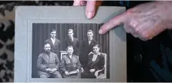  ??  ?? Yelizaveta Mikhaylova, a daughter of a victim of Stalinist repression­s, shows a photo of her parents - father Semyon and mother Antonina - at her house in the village of Zolotkovo.