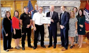  ?? Submitted photo ?? Pictured receiving the grant check in Little Rock on Oct. 13 are: Brenda Rowell, AEDC (left); Cassie Elliott, Visionary Milestones; David Orr; ARDC commission­er James Myatt; Robert Douthit, Gravette fire chief; Gov. Asa Hutchinson; AEDC executive...