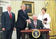  ?? CARLOS BARRIA / REUTERS ?? US President Donald Trump reacts during the swearing in ceremony for new US Secretary of State Rex Tillerson, accompanie­d by his wife Renda St. Clair and Vice President Mike Pence in Washington, DC, on Wednesday.