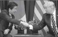  ?? AP/EVAN VUCCI ?? Japanese President Shinzo Abe greets President Donald Trump at a meeting Thursday on the sidelines of the U.N. General Assembly. Abe was supportive of Trump’s new sanctions against North Korea.