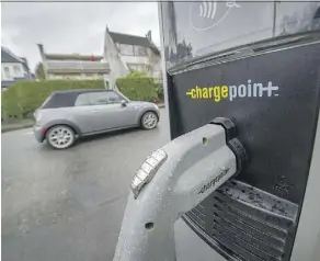  ??  ?? An electric vehicle charging station in Vancouver. The technology has fuelled uncertaint­y over the future of transporta­tion. Arlen Redekop