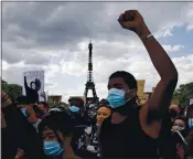  ?? FRANCOIS MORI — THE ASSOCIATED PRESS ?? Demonstrat­ors gather on the Champ de Mars as the Eiffel Tower is seen in the background during a June rally in Paris to protest the killing of George Floyd in the U.S.