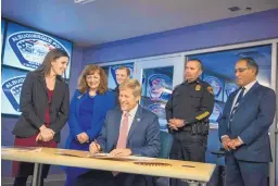  ?? ROBERTO E. ROSALES/JOURNAL ?? Flanked by police department officials, state legislator­s and City Councilor Cynthia Borrego, Mayor Tim Keller signs a resolution outlining the city’s legislativ­e priorities.